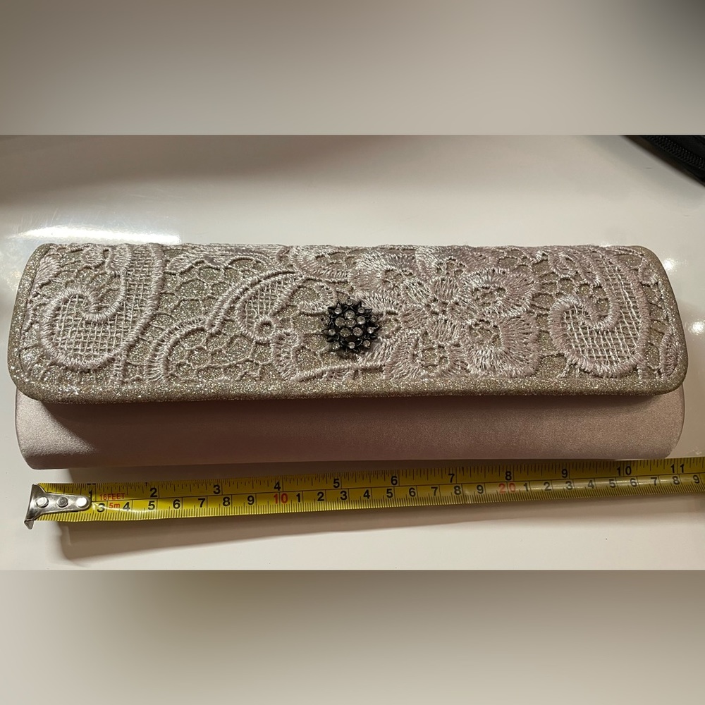 Stunning Champagne colored clutch purse with chain strap.